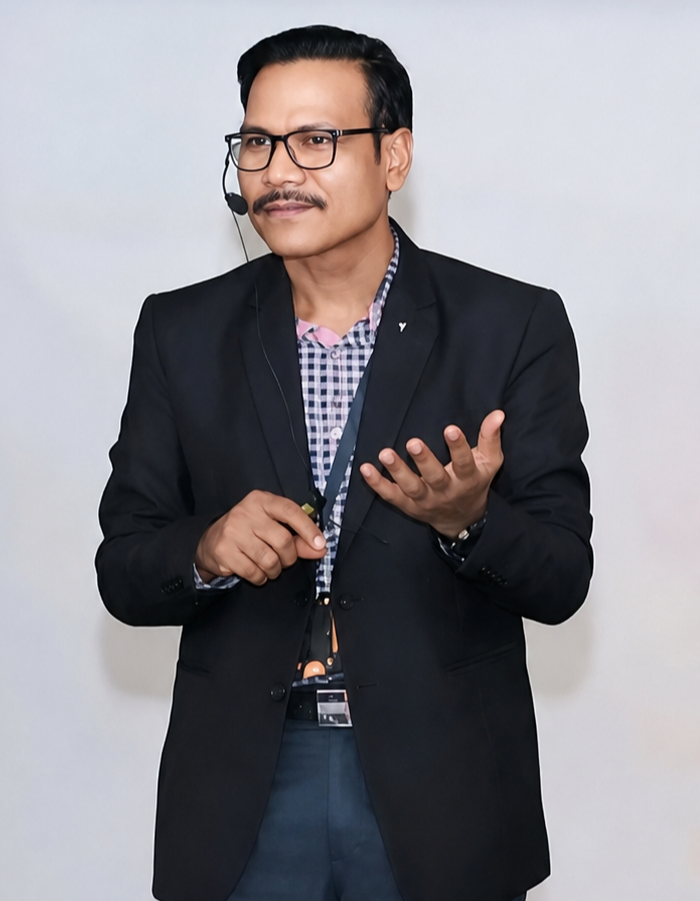Dr. Ajit Kar speaking with a lapel microphone